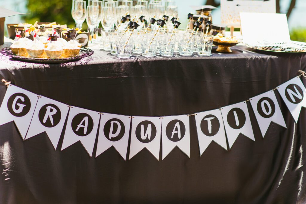 Table of Party Favors with a Banner that Says "Graduation"