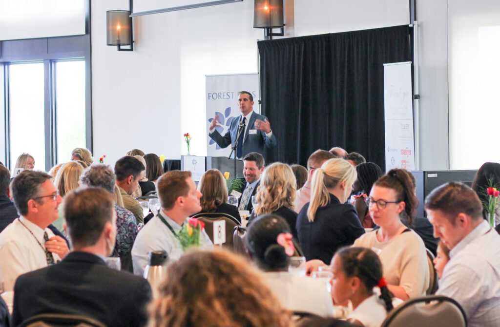 Speaker addressing the audience at a company event