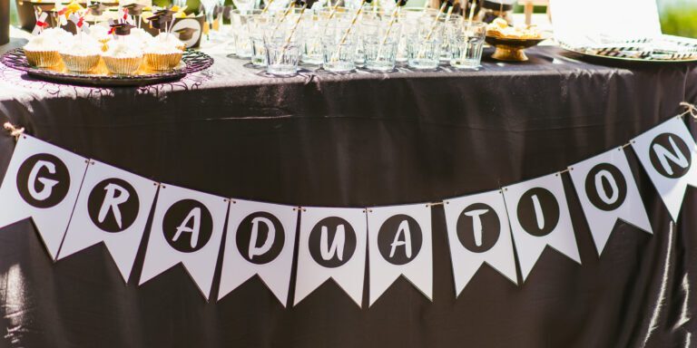 Table of Party Favors with a Banner that Says "Graduation"