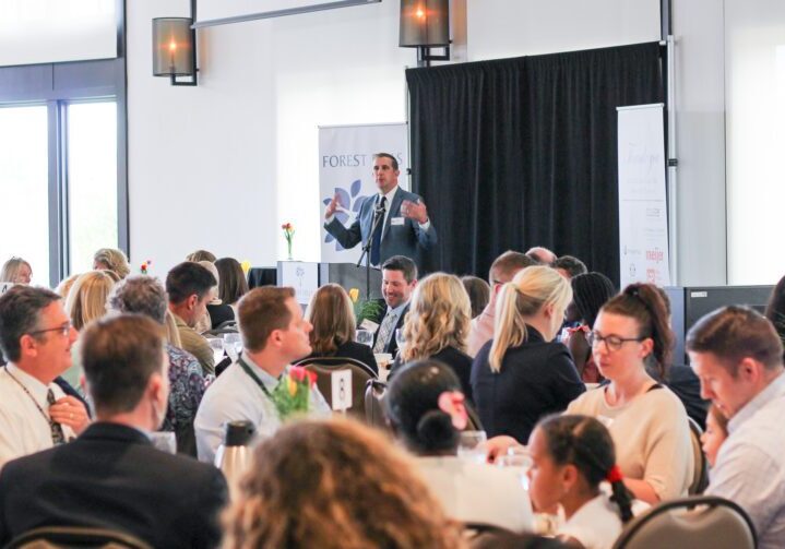 Speaker addressing the audience at a company event