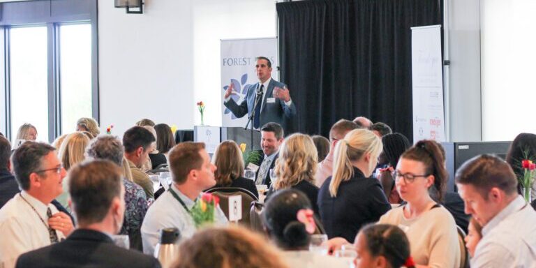 Speaker addressing the audience at a company event